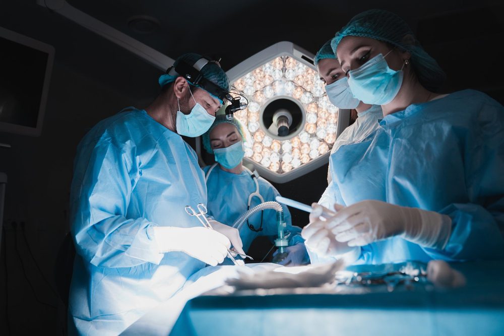 Surgical team performing an operation in a hospital operating room