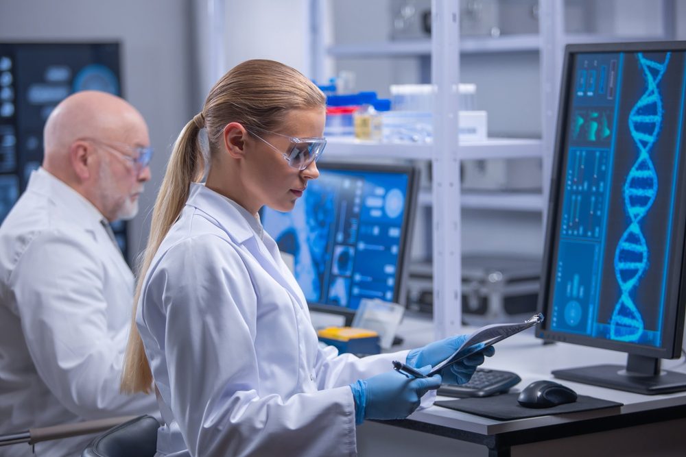 Pharmaceutical and biotechnology researchers reviewing DNA analysis in a laboratory